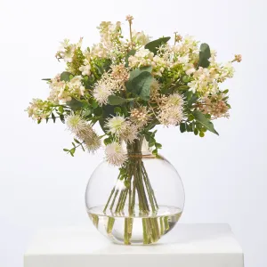 Fuzzy Navel - Peach Thistle Pods & Blush Waxflower with Eucalyptus in Round Ball Amber Vase