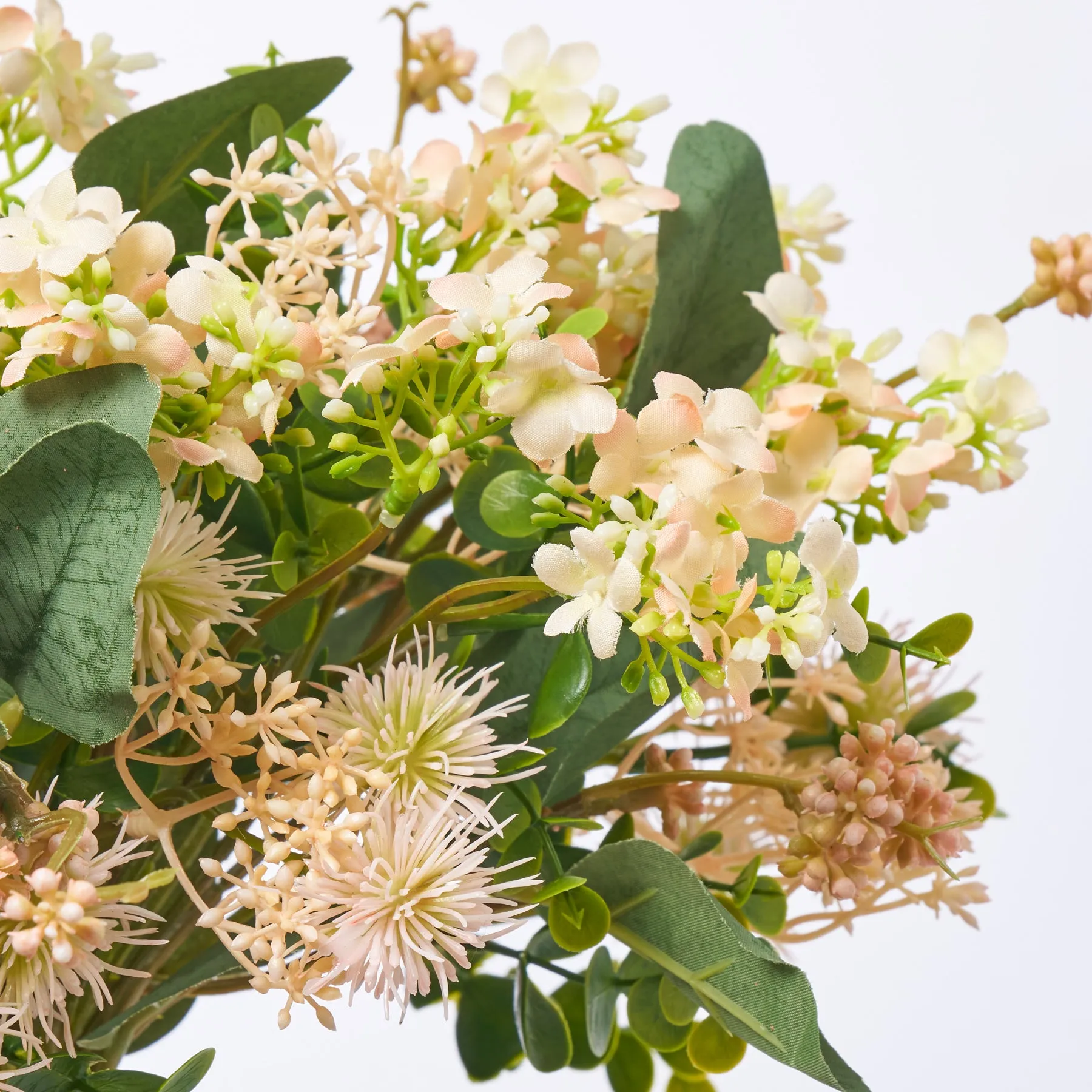 Fuzzy Navel - Peach Thistle Pods & Blush Waxflower with Eucalyptus in Round Ball Amber Vase